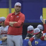 Head coach looks on from the dugout.