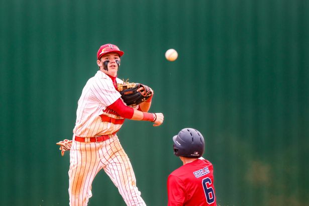 Baseball player attempts to turn a double play.