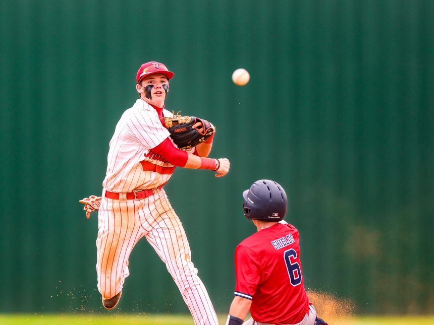 Baseball player attempts to turn a double play.